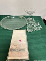 Group shot of platter, six cups, compote and packaged table cover