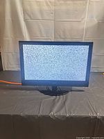 Front view of Coby 23-inch TV displaying static on screen