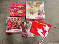 Group shot of four puzzle boxes and car flag