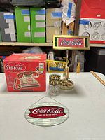 Group shot showing boxed phone, banker lamp, drinking glass, hanging sign