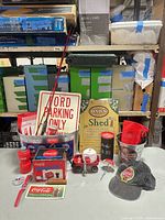 All Coca-Cola items, signs and accessories laid out on table