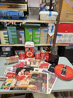 Group shot of all Coca-Cola collectibles laid on table