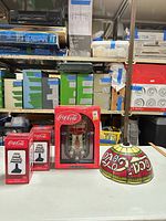 Full lot showing boxed radio, two boxed tealight holders, and plastic dome lampshade