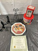 Front view showing plate, tins, stands, certificate