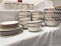 Entire lot showing plates, bowls, mugs, shaker
