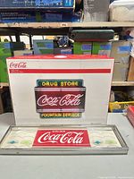 Retail box showing image and branding for Coca-Cola Drug Store Fountain Service neon sign