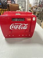 Front view showing Coca-Cola branding, tuning window and control knobs