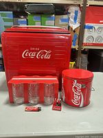 Full lot showing cooler, glasses in sleeve, ice bucket, lighter, bottle opener and mini crate