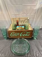 Crate filled with tumblers, signs; tray and two tumblers displayed