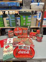 Front view of entire lot showing signs, tray, tins, bucket, towels, bottle and ephemera