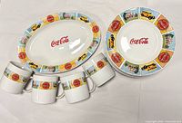 Entire 14-piece set showing platter, round plate and four mugs