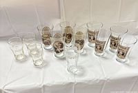 Full group of 13 glasses showing quantity and mix of Mother’s Pizza and Coca-Cola designs