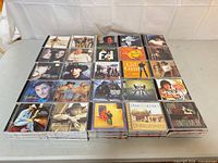 Overview of stacked and grid-arranged country music CDs on table