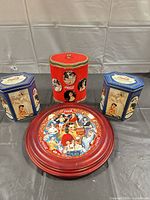 Framed plate and three tins group view