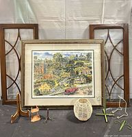 Entire lot: framed print, two window panels, wicker vase, four easels