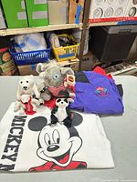 Group shot showing all plush toys, sweatshirt and jacket