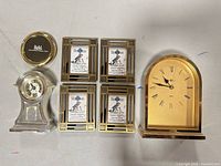 Group shot showing both clocks, four frames, brass dish