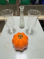 Group of two glass hurricanes, cut glass vase, ceramic pumpkin