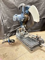 Full view of saw showing power cord, base and clamp