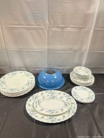 Stacked dinnerware showing two platters, stacks of plates and saucers