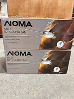 Front view of two sealed NOMA Miles 52" Ceiling Fan boxes