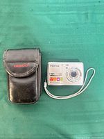 Camera with case on green surface