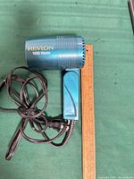 Left side view of Revlon hair dryer alongside ruler