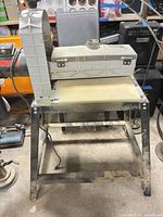 Front view of Ryobi WDS-100 sander mounted on stand