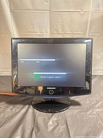 Front view showing powered-on screen with no-signal message