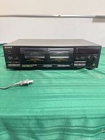 Front view showing dual cassette bays, control buttons, headphone jack