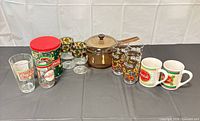 Full lot overview displaying glasses, tin, saucepan and mugs