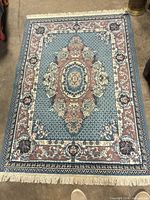 Full view of rectangular fringe-edged rug showing overall pattern and colors