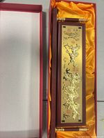Plaque inside open presentation box