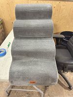 Front view showing three gray knit steps and brand tag