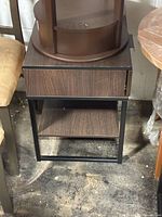Front view of one nightstand showing drawer, shelf and metal frame