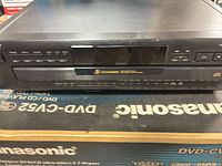 Front view of Sony CDP-CE405 showing display, buttons, disc drawer