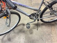 Full side view showing frame, wheels, kickstand and colour scheme