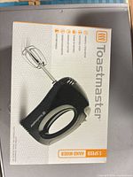 Front of retail box showing Toastmaster 5-speed hand mixer image and branding
