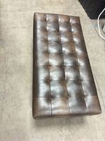 Top view showing rectangular tufted faux leather surface
