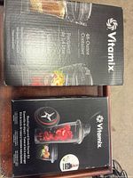 Two boxed Vitamix accessories on table