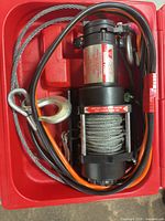 Winch kit in red case showing winch, cables, hook