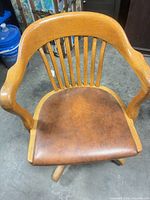 Overhead view showing spindle back, armrests and brown vinyl seat