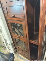 Full view of cabinet showing drawers, mirrored door and shelves