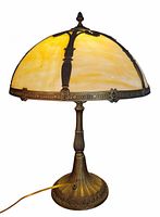 Full view of lamp lit showing slag glass shade and metal overlay