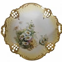 Front view showing floral design, scalloped rim and gilt accents