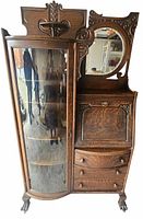 Full view of oak side-by-side showing glass cabinet, secretary desk, drawers, mirror, carved crest, claw feet