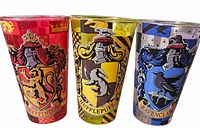 Three colored crest glass tumblers grouped together