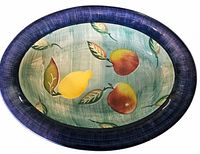 Top view of Italian ceramic bowl with fruit motif and blue rim
