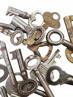 Pile of assorted metal keys showing various shapes and finishes