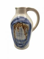 Front view of stoneware pitcher showing abstract cobalt and brown design